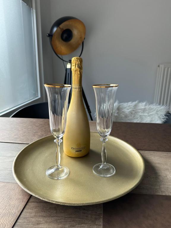 a plate with a bottle of champagne and two glasses at Antwerp West Side in Zwijndrecht