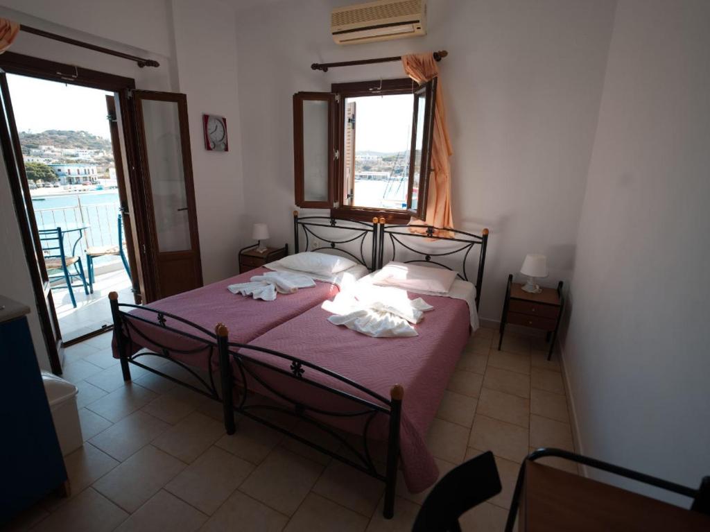 A bed or beds in a room at Calypso Hotel