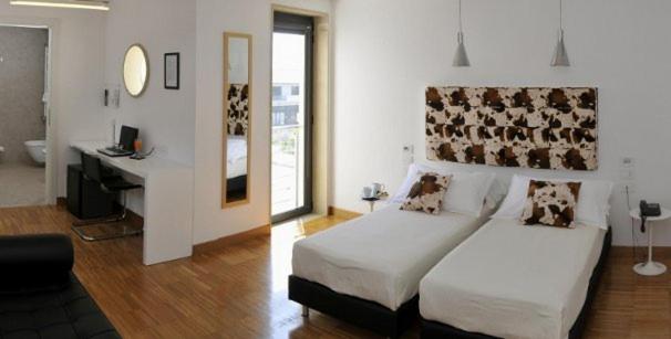 Postel nebo postele na pokoji v ubytování Hotel Del Conte