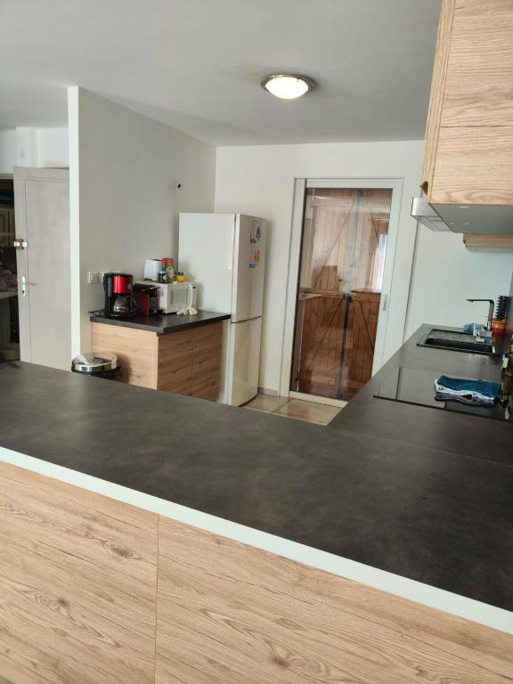 a kitchen with a large counter top in a room at Maison de 2 chambres avec vue sur la mer jardin clos et wifi a Sete in Sète