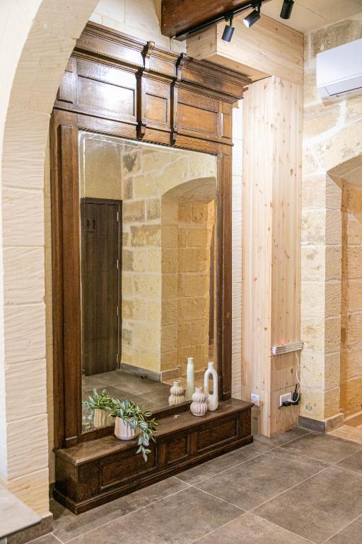 a bathroom with a large mirror on a wall at 49 Sunrise Lodge in Għajnsielem