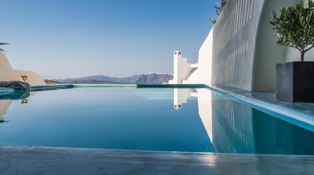a swimming pool with a view of the mountains at Black Diamond Suites in Akrotiri