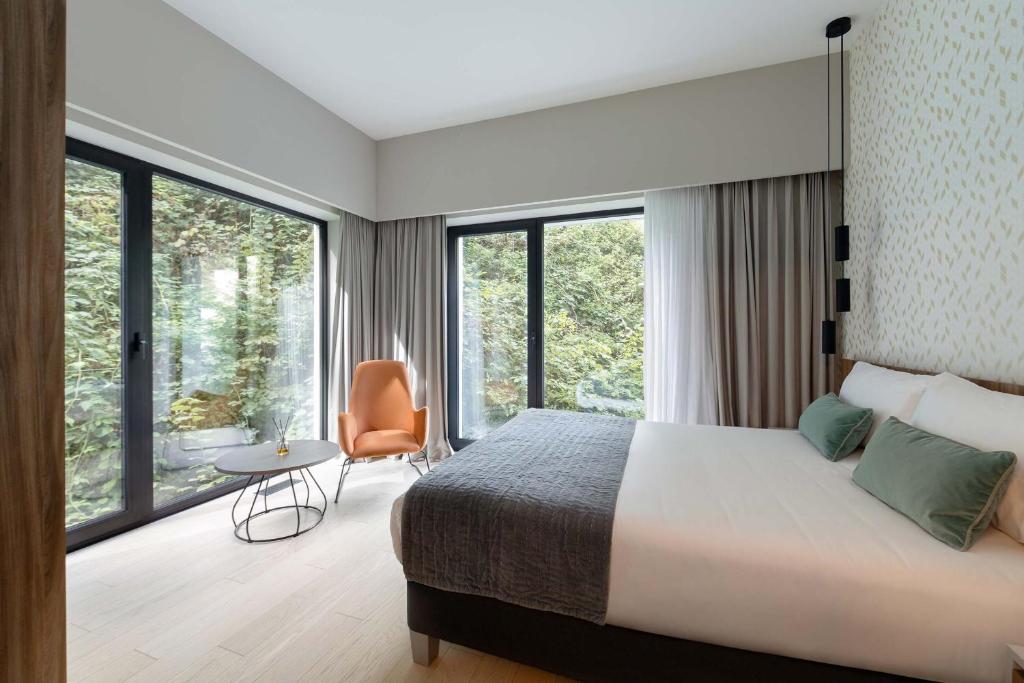 Postel nebo postele na pokoji v ubytování The Central Kirchberg - Smart ApartHotel