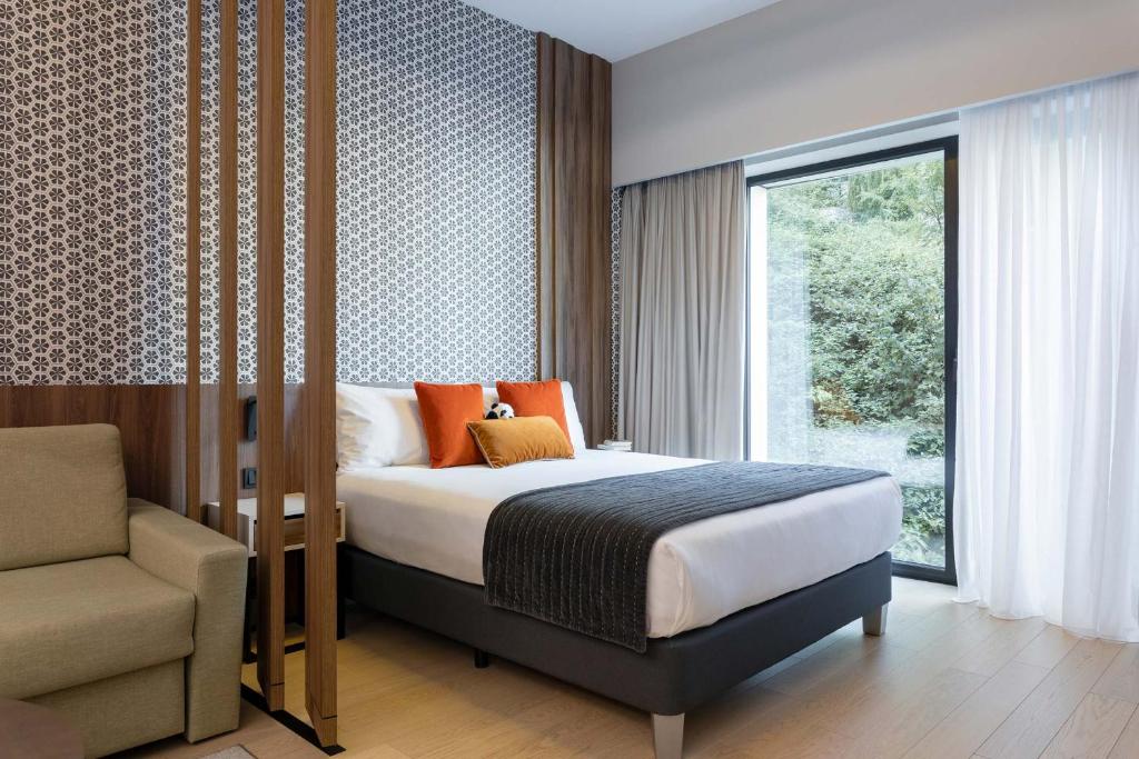 Postel nebo postele na pokoji v ubytování The Central Kirchberg - Smart ApartHotel
