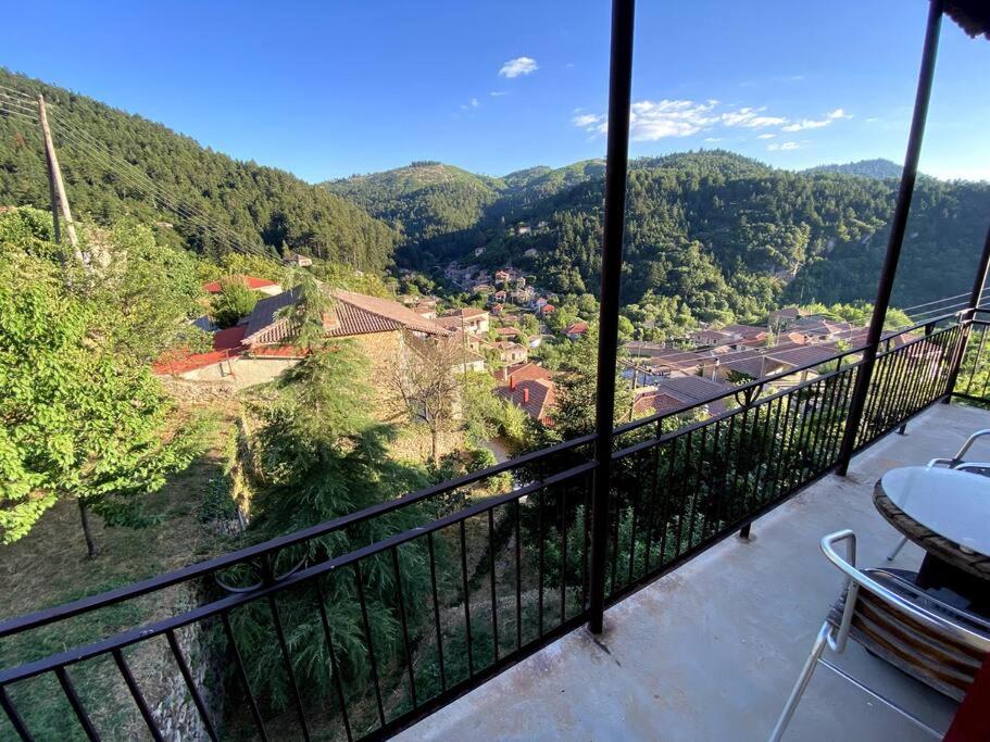 a balcony with a view of the mountains at Το Aρχοντικό των Τσιντζίνων in Polídhroson