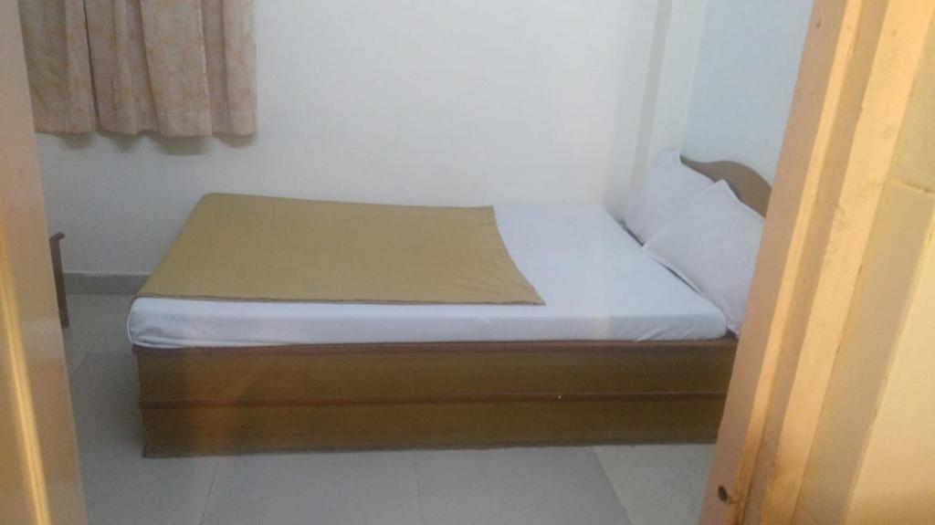 Postel nebo postele na pokoji v ubytování MYSORE MAHALAKSHMI ROOMS