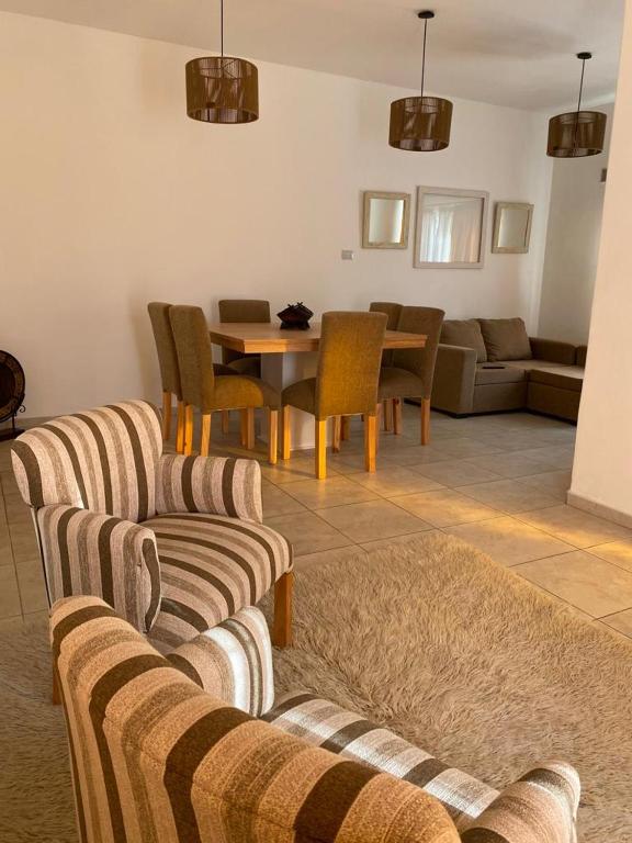 a living room with two couches and a table at CASA ALQUILER TEMPORAL VILLA CABRERA in Córdoba