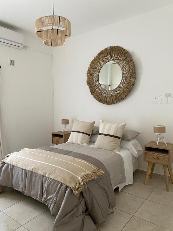 a bedroom with a bed and a mirror on the wall at CASA ALQUILER TEMPORAL VILLA CABRERA in Cordoba