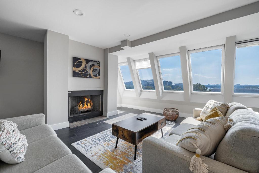 a living room with a couch and a fireplace at Georgetown Residences by LuxUrban in Washington, D.C.