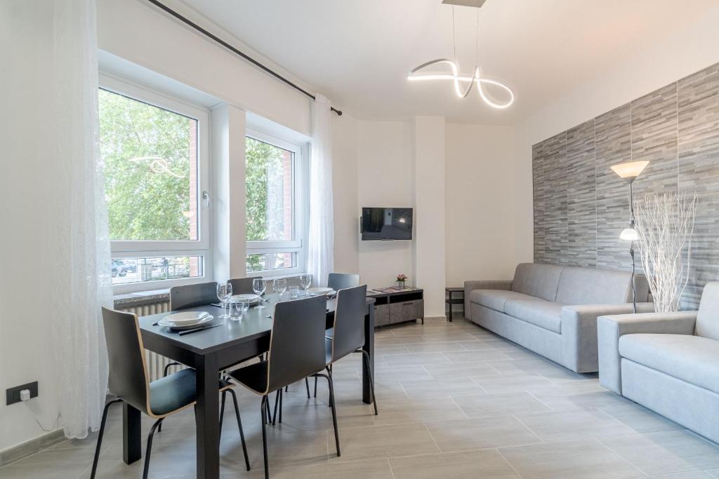 - une salle à manger et un salon avec une table et des chaises dans l'établissement Welcome to Turin! Apartment Regina Margherita, à Turin