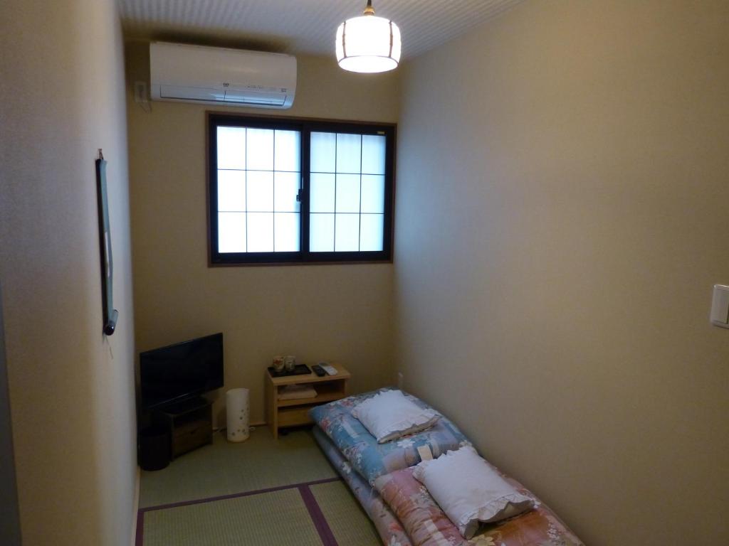 Postel nebo postele na pokoji v ubytování Guesthouse Engawa