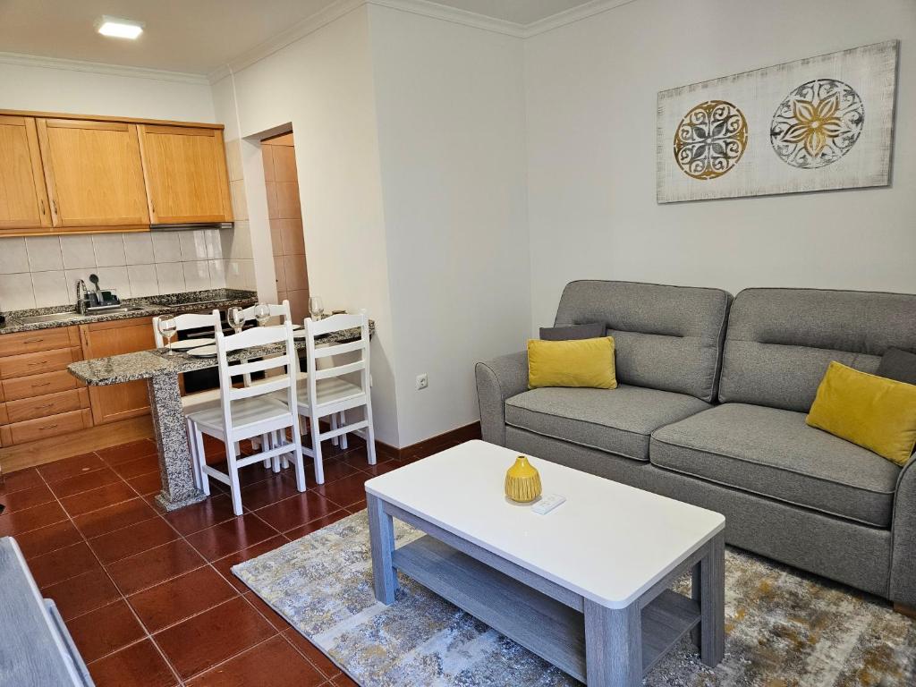 a living room with a couch and a table at Apartamento Costa Norte in Porto Moniz