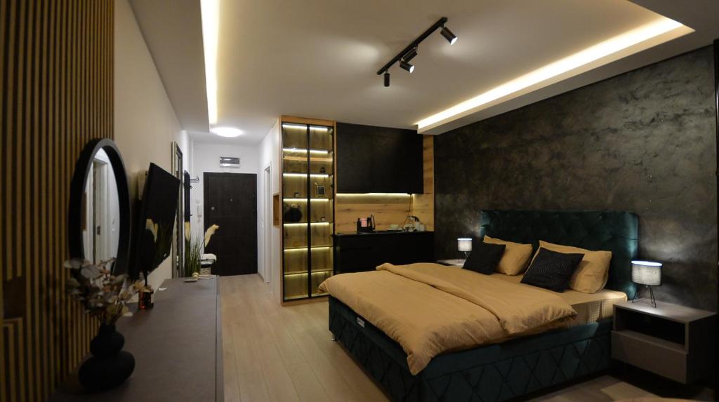 una camera con un grande letto e un grande specchio di Nia Lux Apartman a Belgrado