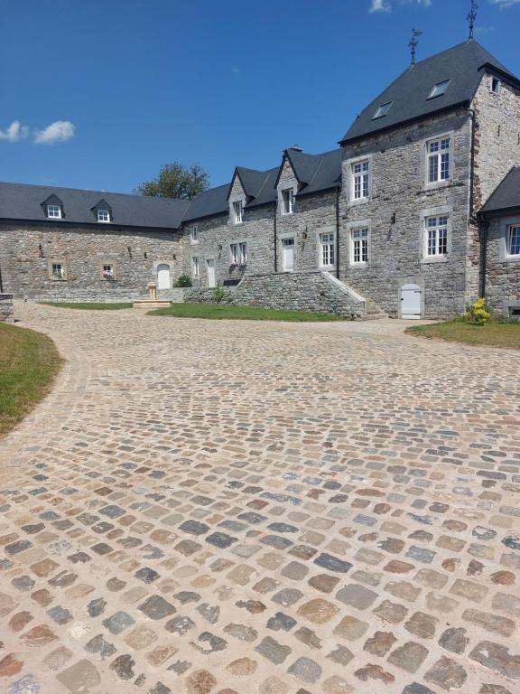 a stone road in front of a stone building at La Ferme de Sotrez 