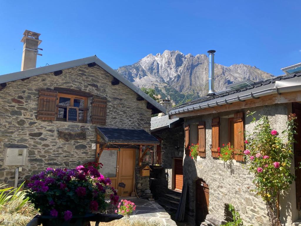 a stone house with a mountain in the background at chalet st michel de maurienne in Beaune