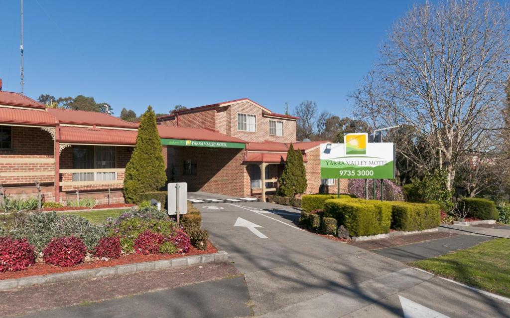 a large green building with a sign on the side of it at Yarra Valley Motel in Lilydale