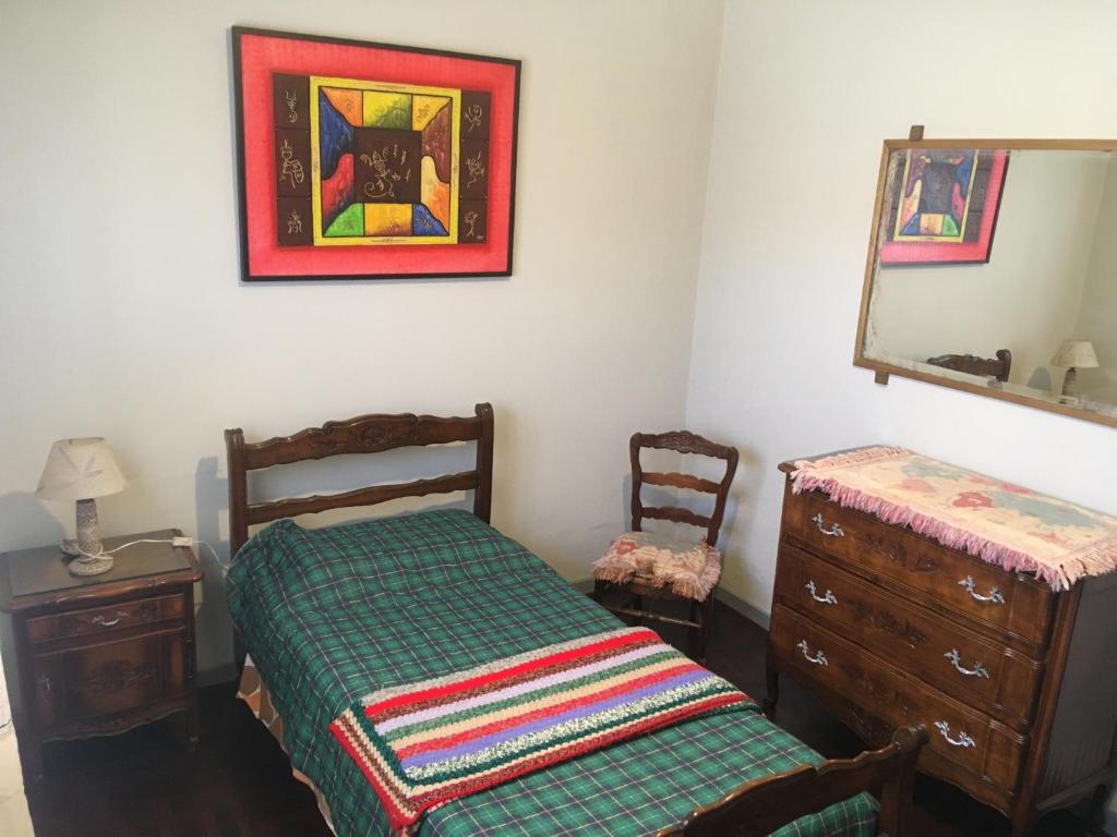 a bedroom with a bed and a dresser and a mirror at TERRAZAS DEL SUR in Ezpeleta