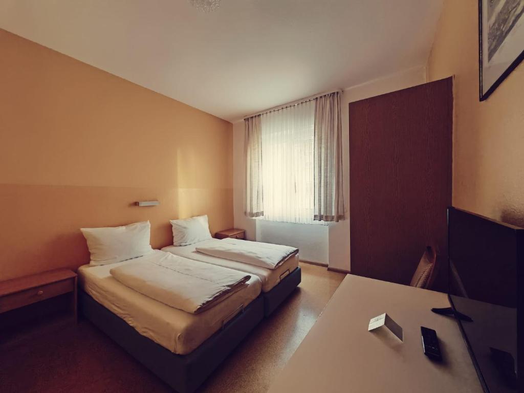 a hotel room with a bed and a desk at City Hotel Bauer mit Aufzug with elevator in Nürnberg