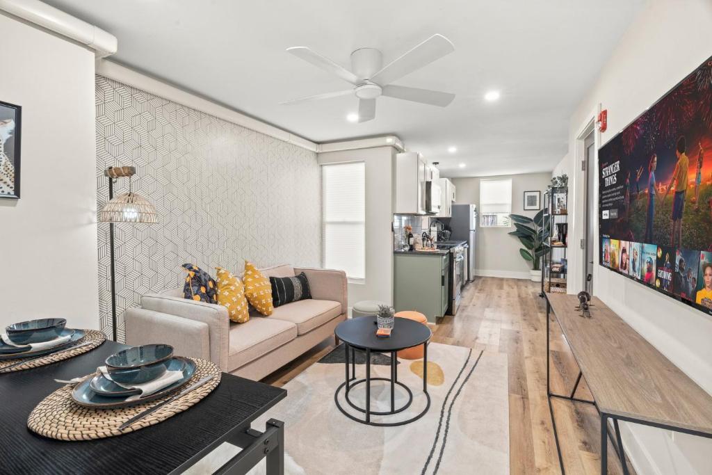 uma sala de estar com um sofá e uma mesa em 1 BR Passyunk Ave Stunner- Perfect Location em Filadélfia