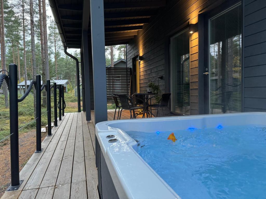 a hot tub on a porch of a house at Villa Dyyni Yyteri - Sauna & Hot Tub - Near Beach in Pori
