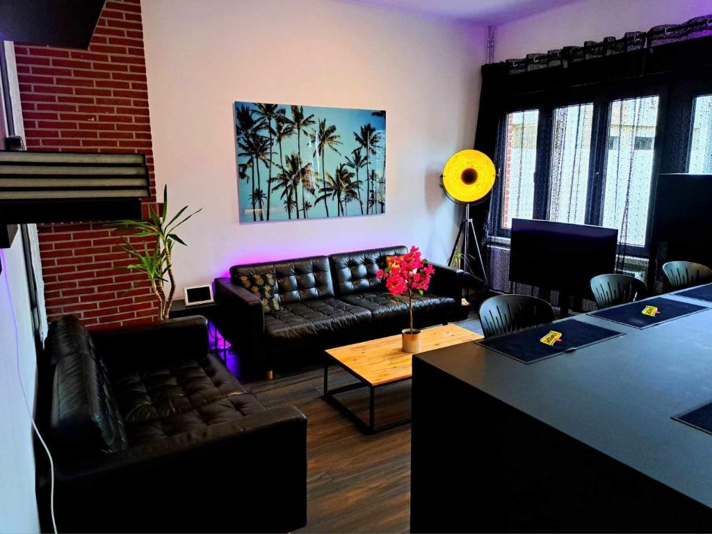 a living room with a couch and a table at Chambre dans une maison d'hote in Liège