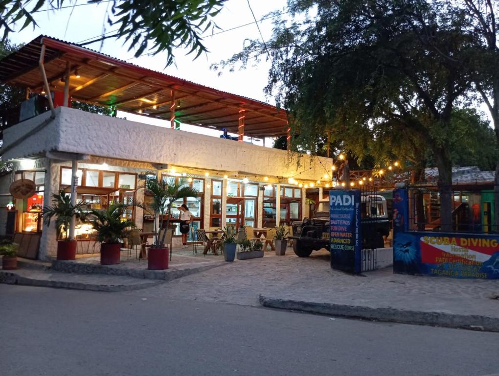 a restaurant with a building with lights on it at Taganga Paradise Hostal Diving in Taganga