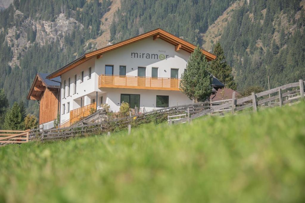 a building on top of a hill next to a mountain at Living Miramor in Racines