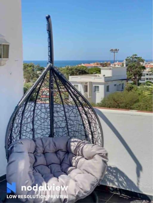 a pillow in a basket on top of a balcony at HIMALAYA ROOFTOP Sea VIEW in Albufeira