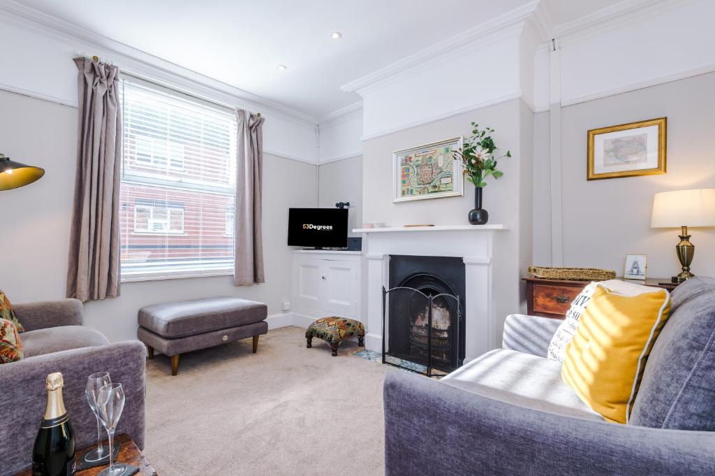 a living room with two couches and a fireplace at Central 2-bed home in Chester by 53 Degrees Property - Amazing location, Ideal for Couples - Sleeps 4! in Chester