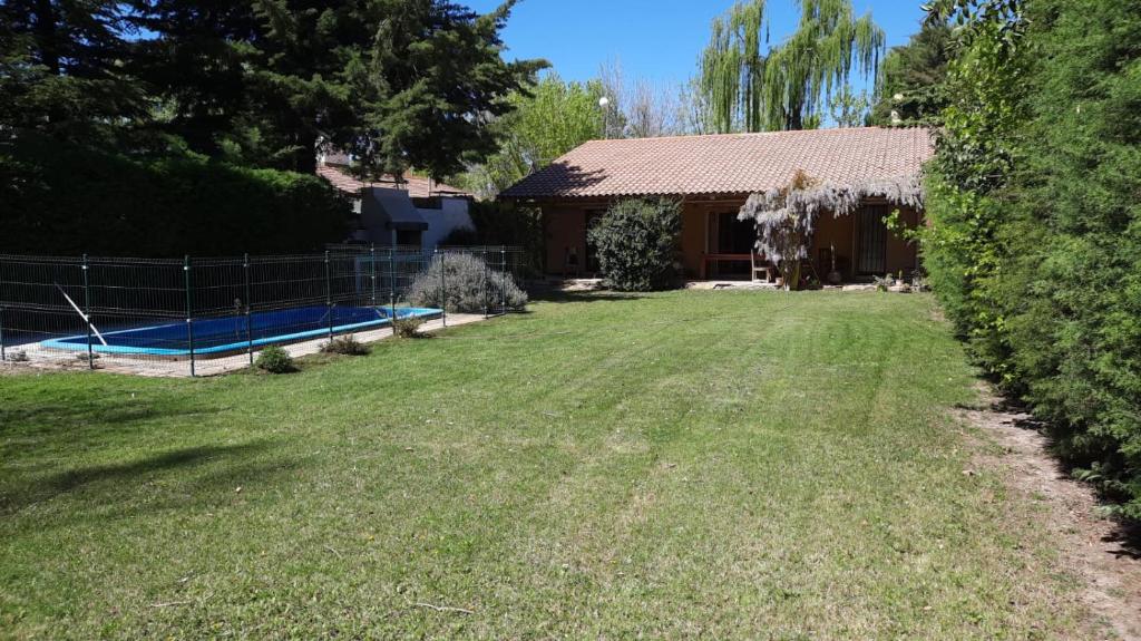 a large yard with a house and a pool at La Esperanza in Ciudad Lujan de Cuyo