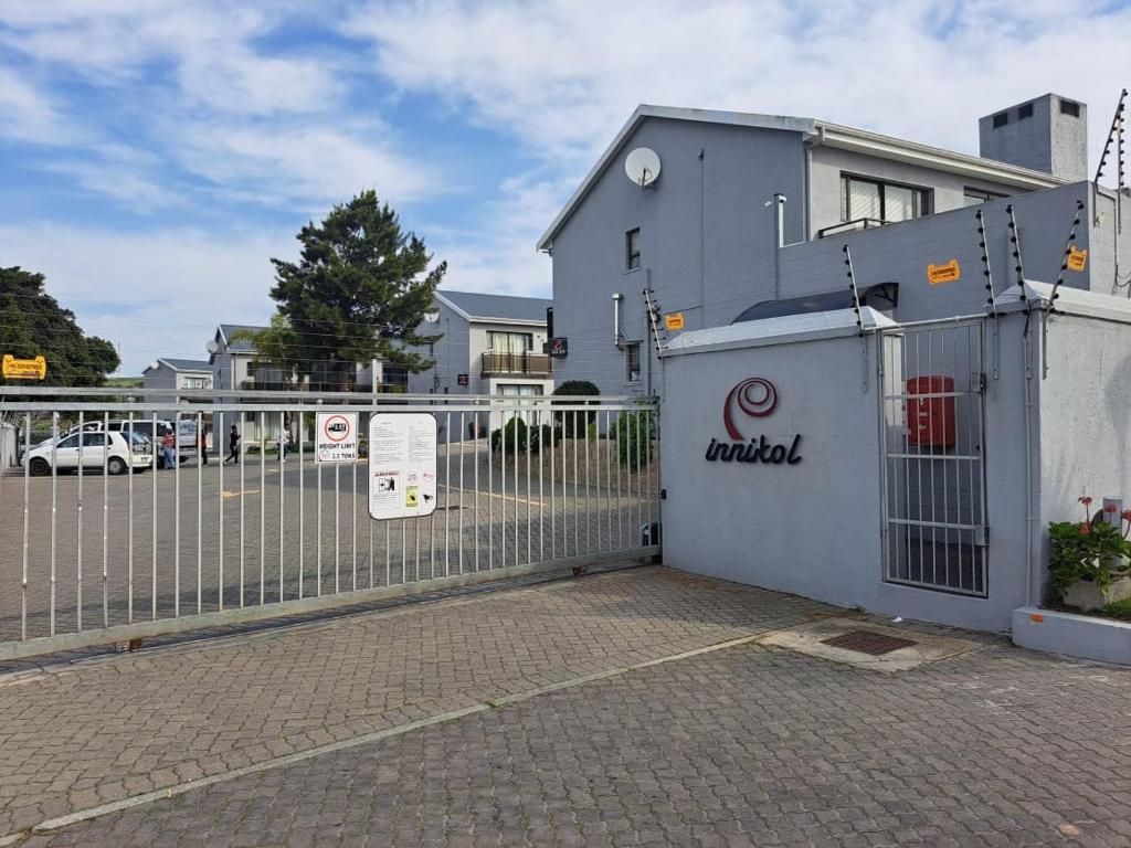 a fence in front of a building with a gate at INNIKOL 55 in Mossel Bay
