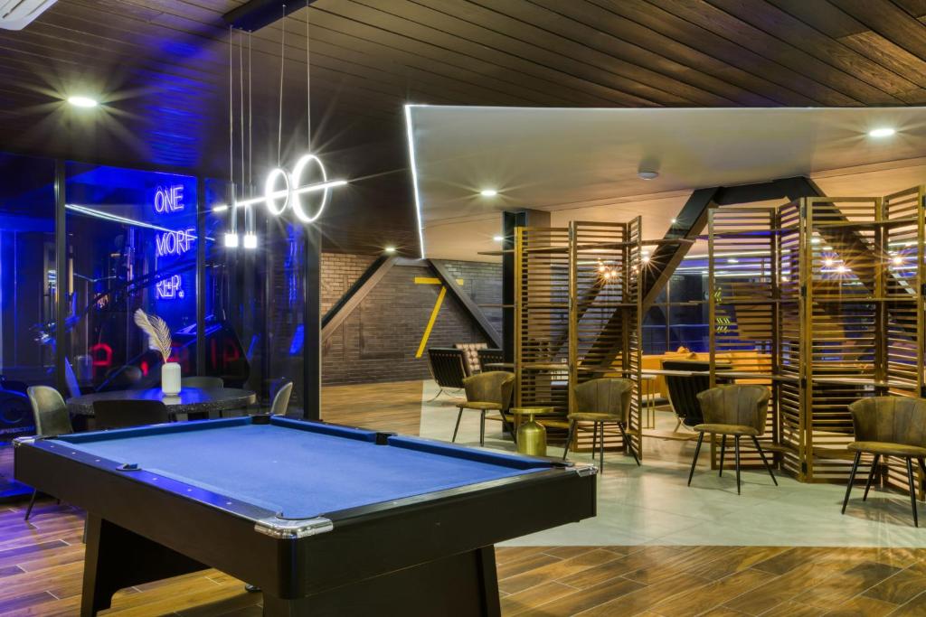 a pool table in a room with a bar at Downtown Designer Apartments by ULIV in Tijuana