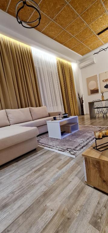 a living room with a couch and a table at LUXURY APARTMENT in Tirana