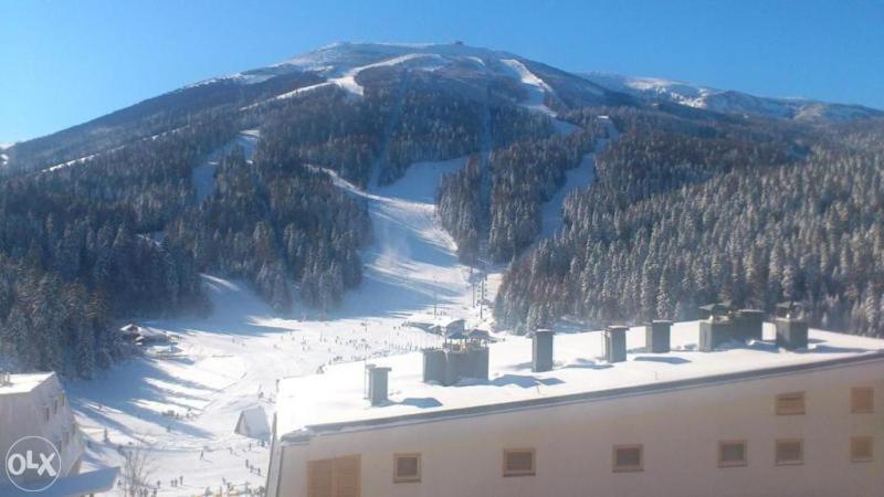 uma vista para uma montanha coberta de neve com um edifício em Apartman Babin Do Bjelasnica em Sarajevo