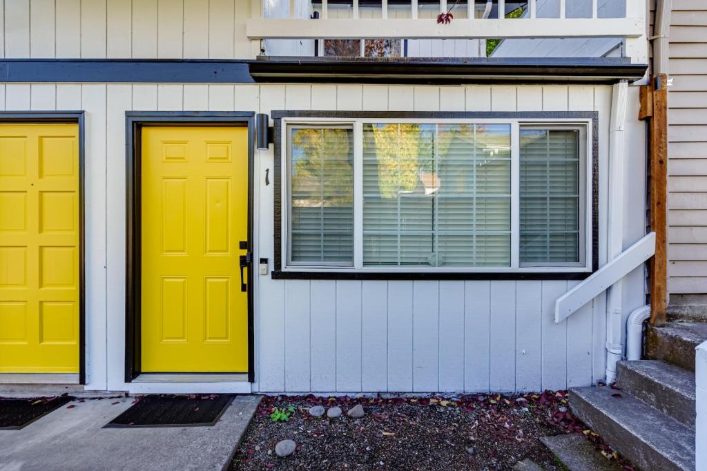 two yellow doors on the side of a house at Retreat near UO, Autzen Stadium, Amazon Park (# 1) in Eugene
