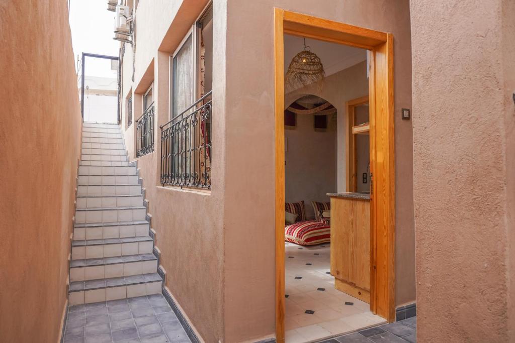 a hallway with stairs leading up to a building at SurfAppart Morocco in Tamraght Ouzdar