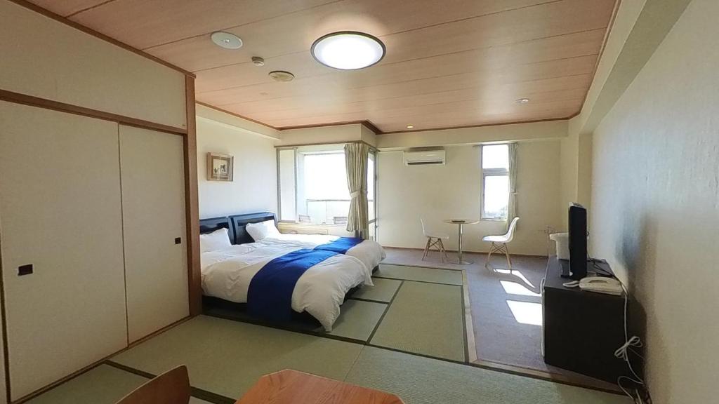 a bedroom with a bed and a television in it at HOTEL GREEN PLAZA SHODOSHIMA - Vacation STAY 51989v in Ikisue