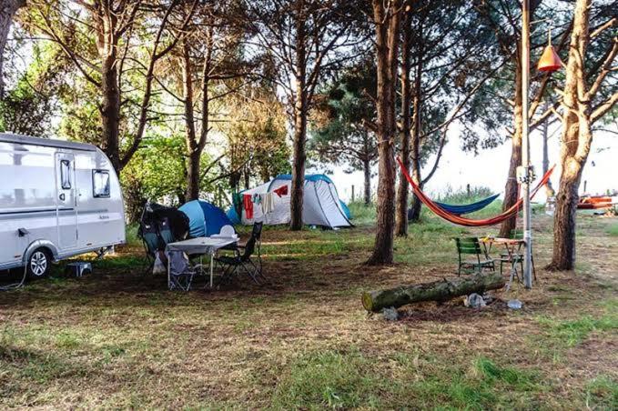 a campsite with a van and tents and a hammock at Camping çuğra in Erdek