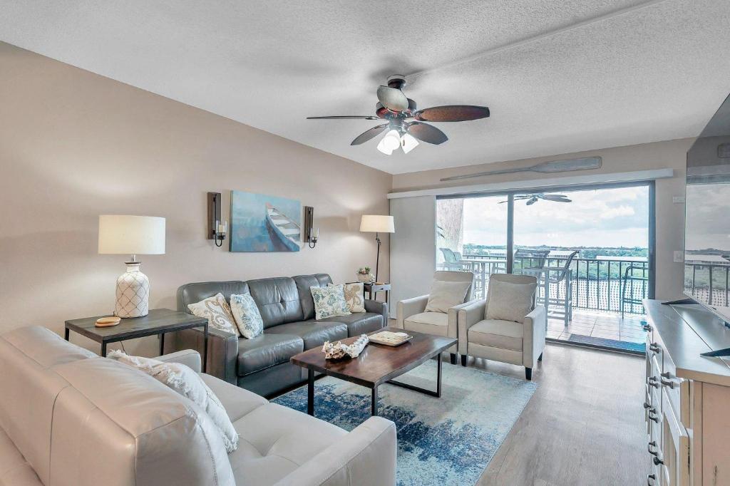 a living room with a couch and a ceiling fan at Pet-friendly 2-bed Condo With Amazing Waterfront Views in Clearwater Beach