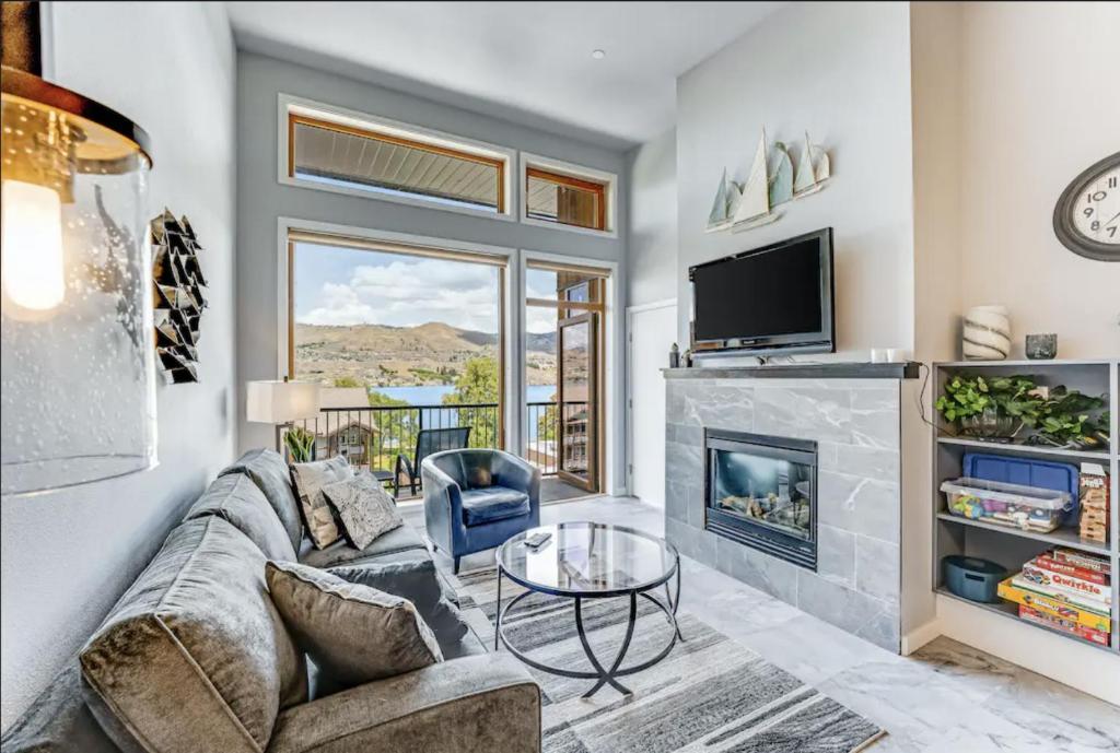 a living room with a couch and a fireplace at Chelan Resort Suites by DC in Chelan