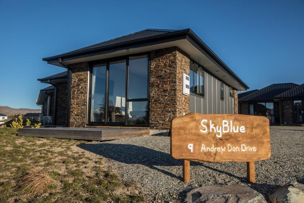 a building with a sign in front of it at Skyblue Tekapo in Lake Tekapo