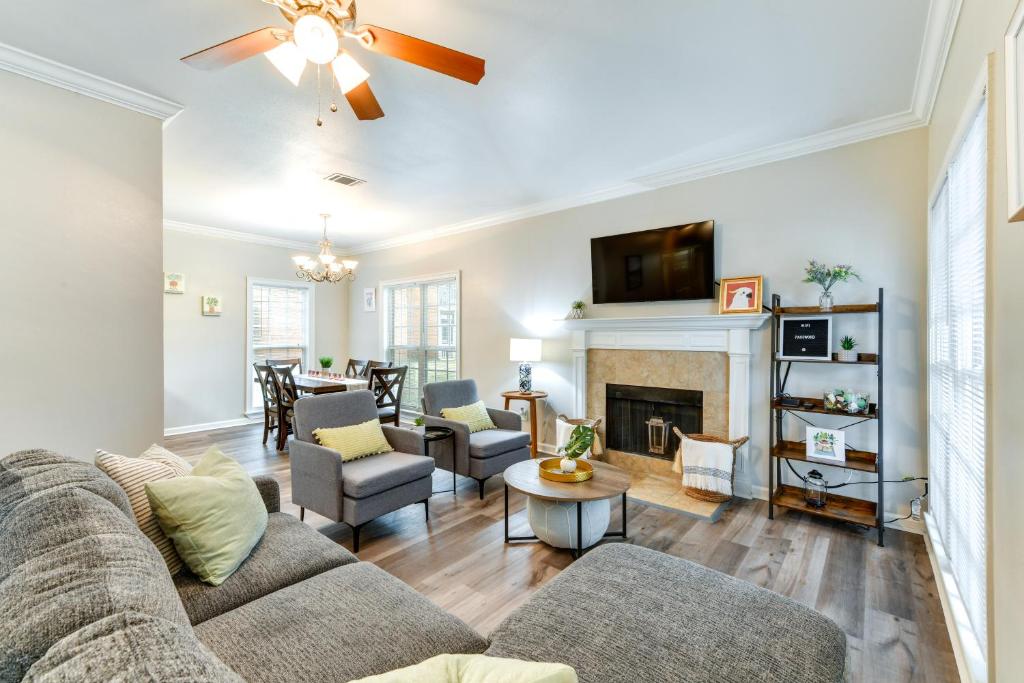 a living room with a couch and a fireplace at Baton Rouge Condo with Community Pool 6 Mi to LSU! in Baton Rouge