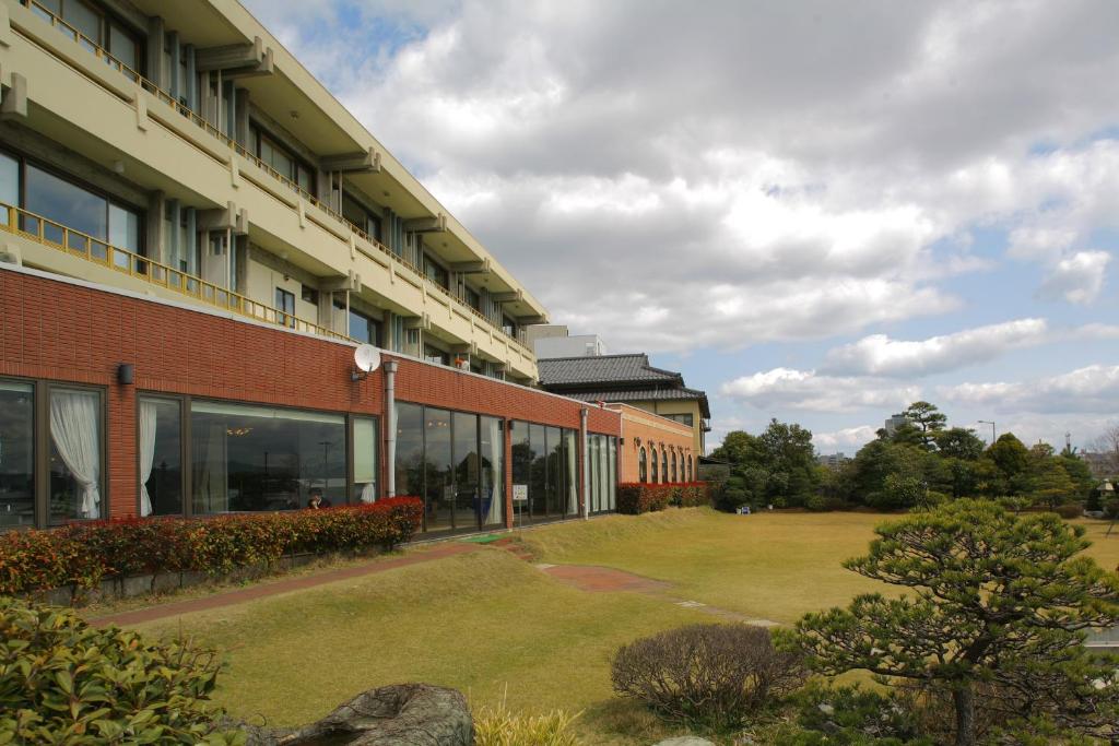 a large building with a lawn in front of it at Ryokan Yukeikohan Suitenkaku in Matsue