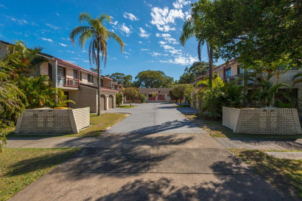 a street in a neighborhood with palm trees and houses at Kenway Lodge in Ballina