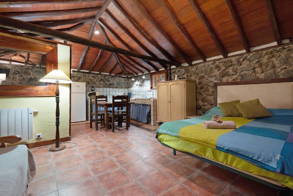 a bedroom with a bed with a teddy bear laying on it at Eritía in Icod de los Vinos