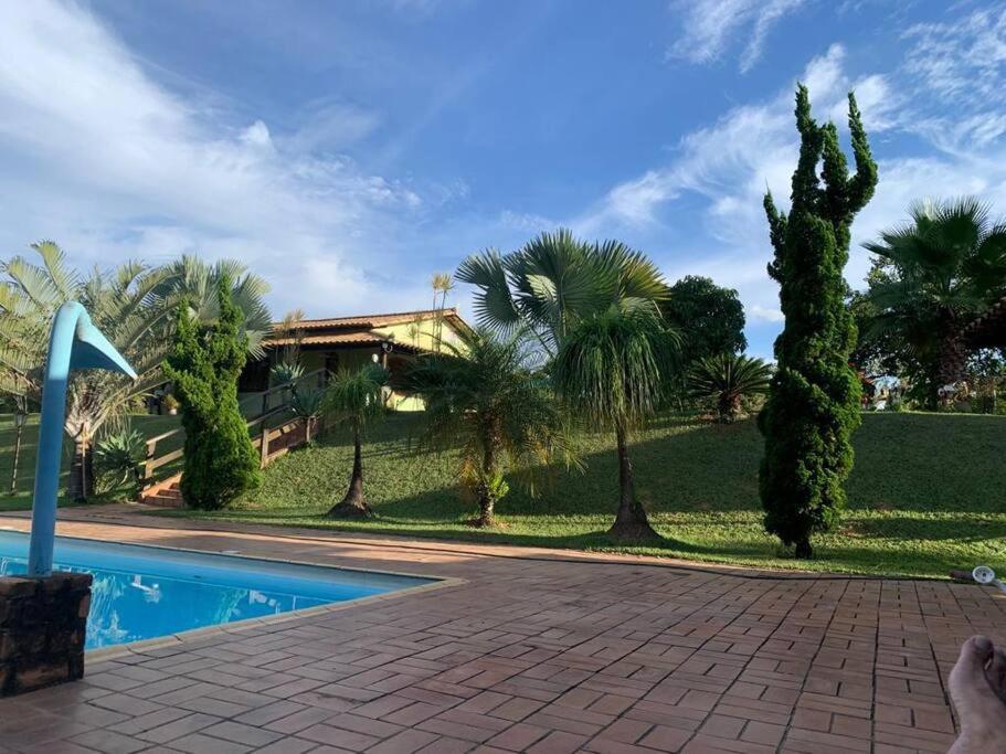 uma casa com piscina e palmeiras em Sitio Morada da Felicidade em Esmeraldas