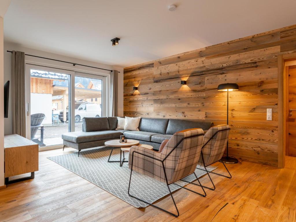 a living room with a couch and a table and chairs at Mountain Chalet Dahoam in Sankt Lorenzen ob Murau