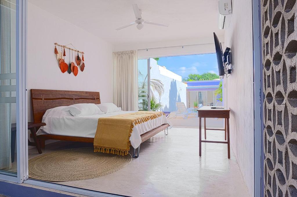 una camera con letto e porta scorrevole in vetro di Casa Violeta a Mérida
