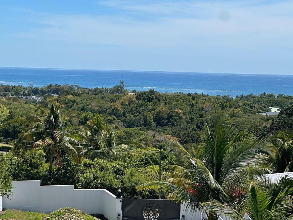 a view of the ocean from a house at VILLA 3 GRANDE CHAMBRES 4 étoiles in Sainte-Anne