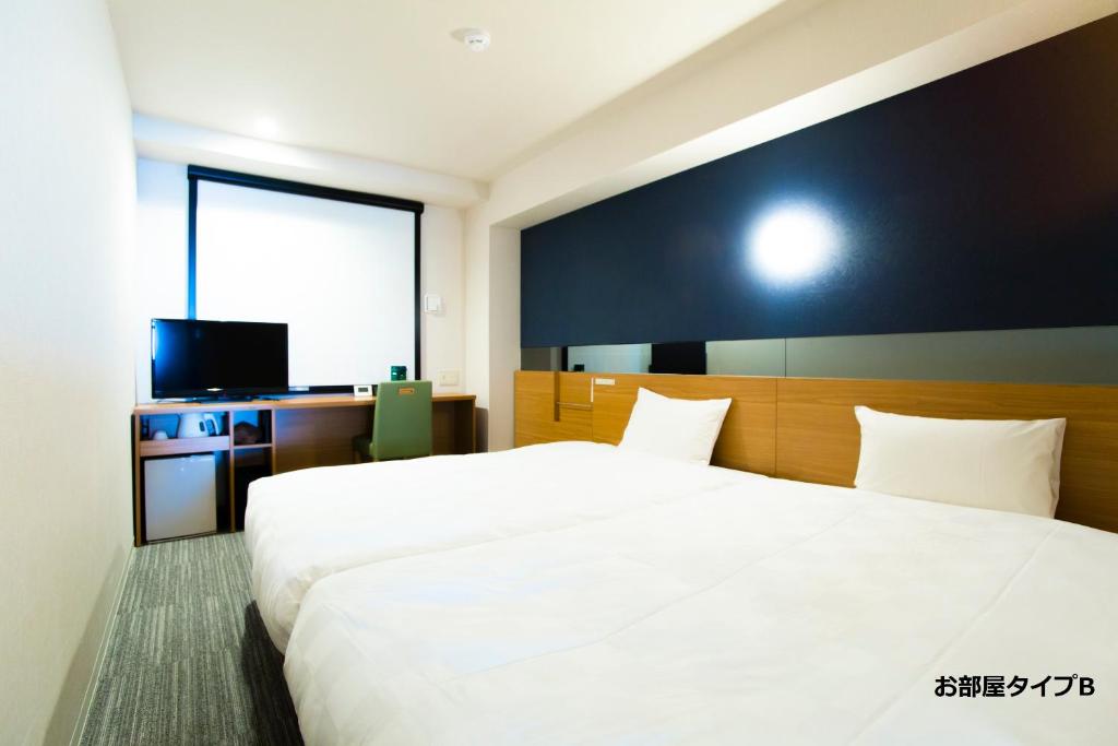 Postel nebo postele na pokoji v ubytování Hotel Meldia Kyotoshijoomiya